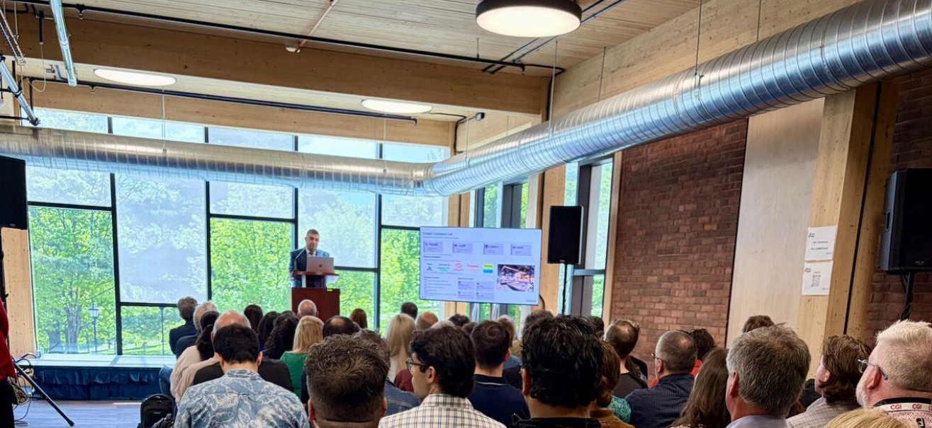 Amir Tavasoli presenting at the Atlantic AI Summit 2026 to a full audience at the University of New Brunswick